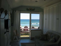 Sliding glass door frames the colors of the sea